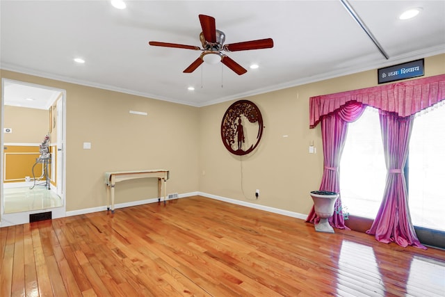 empty room featuring crown molding, recessed lighting, ceiling fan, light wood-type flooring, and baseboards