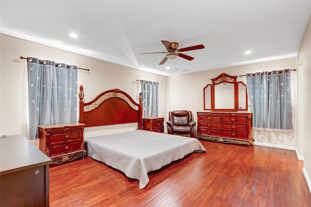 bedroom featuring baseboards, a ceiling fan, wood finished floors, and recessed lighting