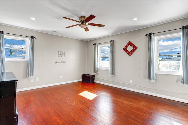 empty room with hardwood / wood-style flooring and a healthy amount of sunlight