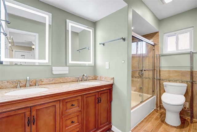 full bathroom featuring double vanity, a sink, and toilet