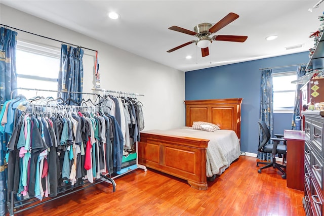 bedroom featuring recessed lighting, wood finished floors, a ceiling fan, baseboards, and visible vents