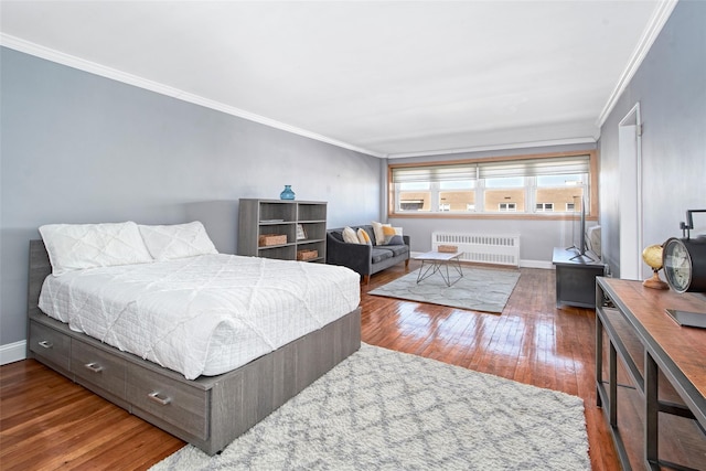 bedroom with crown molding, radiator heating unit, and dark hardwood / wood-style flooring