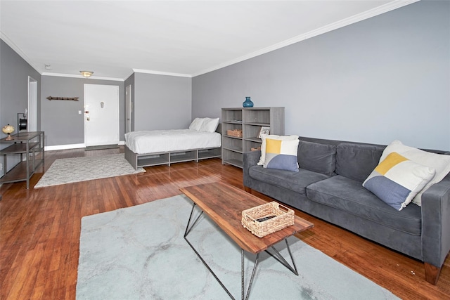 bedroom with dark wood-type flooring and ornamental molding