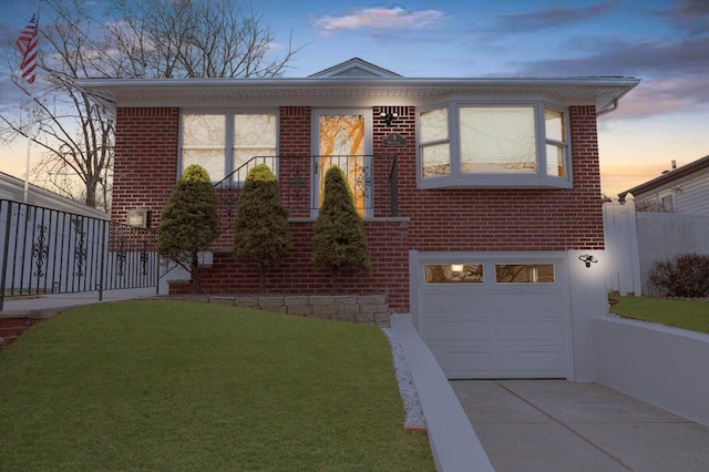 view of front of house with a lawn and a garage