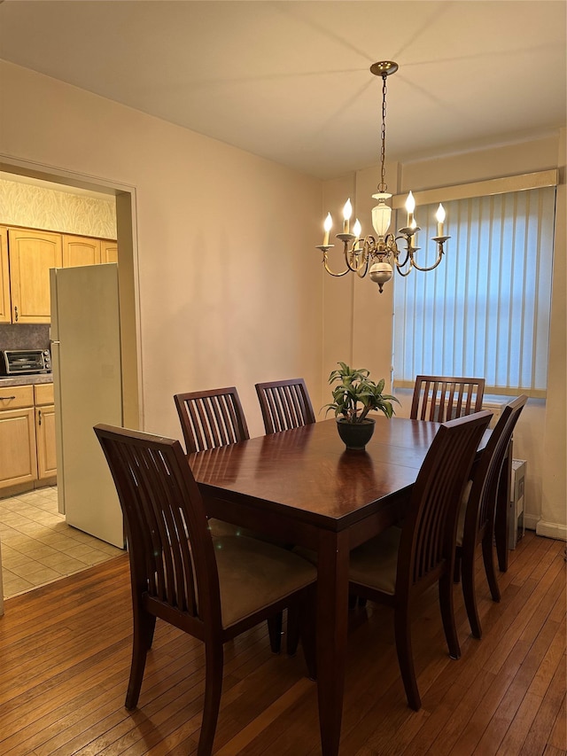 dining room featuring a chandelier and light hardwood / wood-style floors