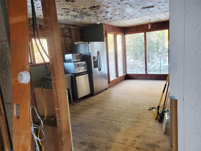 kitchen with stainless steel refrigerator with ice dispenser and hardwood / wood-style floors