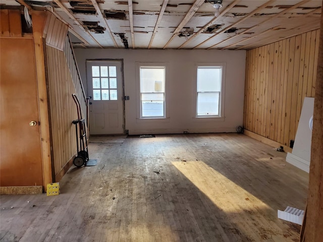 miscellaneous room featuring wooden walls and light wood-type flooring