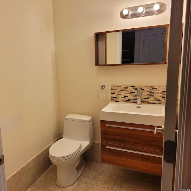 bathroom featuring decorative backsplash, tile patterned floors, vanity, and toilet