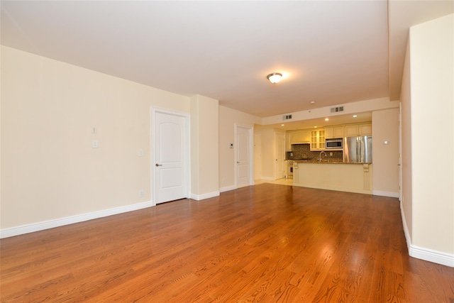 unfurnished living room with hardwood / wood-style floors