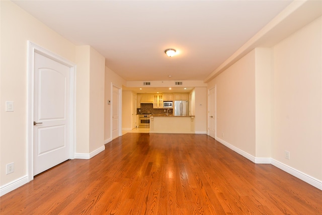 unfurnished living room featuring wood-type flooring