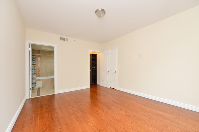 empty room with light hardwood / wood-style floors