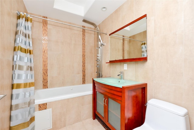 full bathroom featuring shower / bath combo, tile patterned floors, sink, toilet, and tile walls