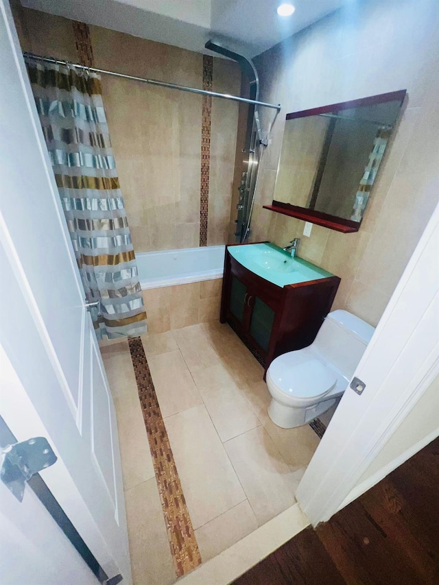 full bathroom featuring tile patterned floors, shower / tub combo with curtain, vanity, and toilet