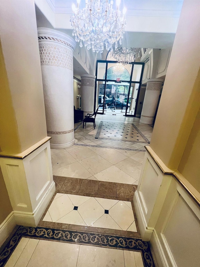 hallway featuring light tile patterned floors and a notable chandelier