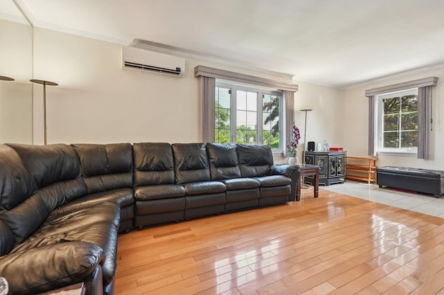 living room with hardwood / wood-style flooring, an AC wall unit, crown molding, and a healthy amount of sunlight