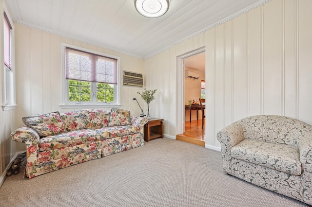 sitting room featuring an AC wall unit, light colored carpet, and ornamental molding