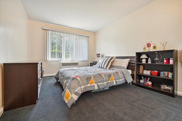 bedroom with radiator, dark colored carpet, and lofted ceiling