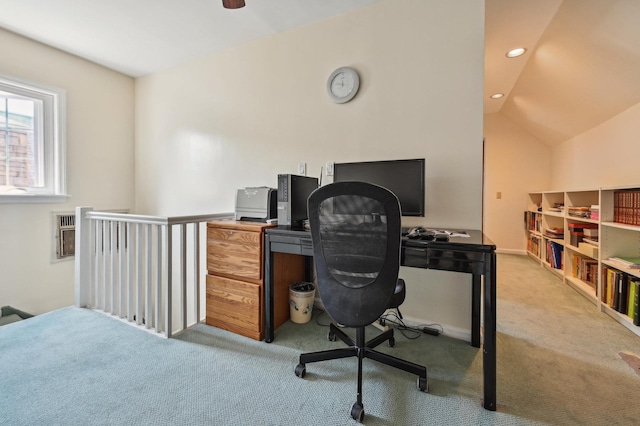 carpeted home office featuring lofted ceiling