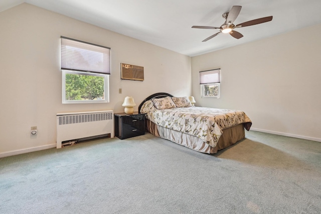 bedroom featuring carpet, radiator, and ceiling fan