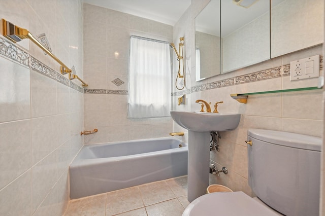 bathroom featuring toilet, tile patterned flooring, and tile walls