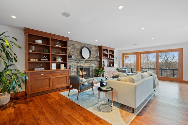 living room with a fireplace and light hardwood / wood-style floors