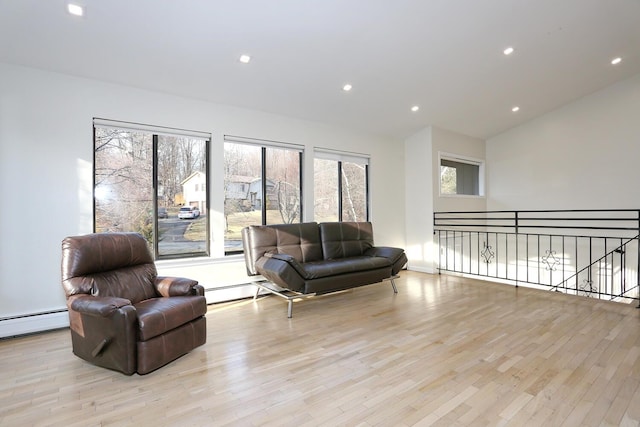 living room with baseboard heating and light wood-type flooring