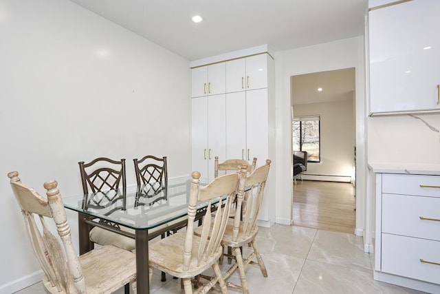 dining room featuring a baseboard heating unit