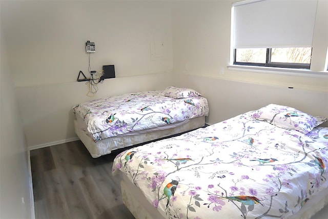 bedroom with dark wood-type flooring