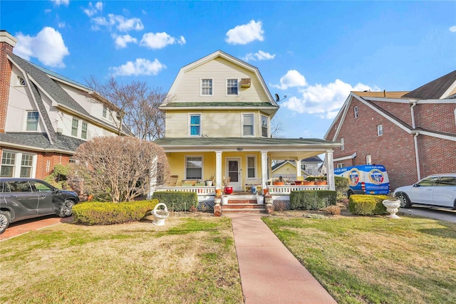 view of front facade with a front yard and a porch