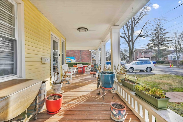 wooden terrace featuring covered porch