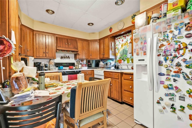 kitchen featuring white appliances and light tile patterned flooring