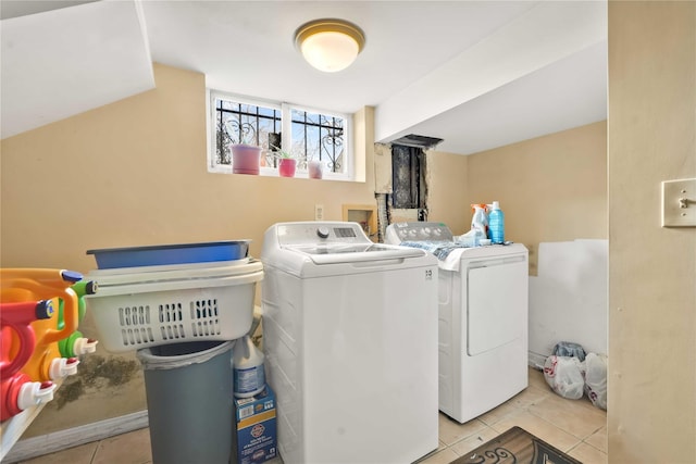 washroom featuring washer and dryer and light tile patterned flooring