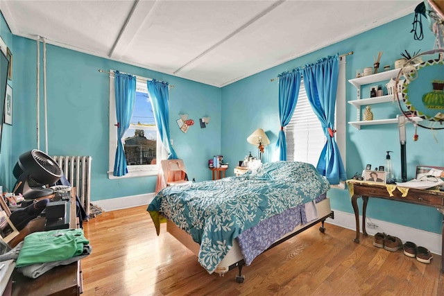 bedroom featuring wood-type flooring and radiator