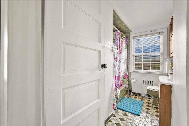 full bathroom featuring shower / tub combo, vanity, toilet, and radiator