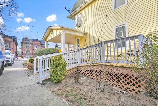 view of home's exterior with cooling unit and covered porch