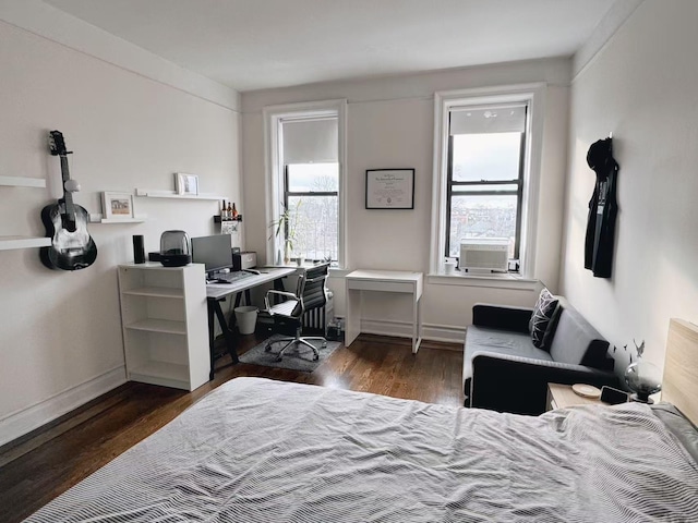 bedroom with dark hardwood / wood-style floors, multiple windows, and cooling unit