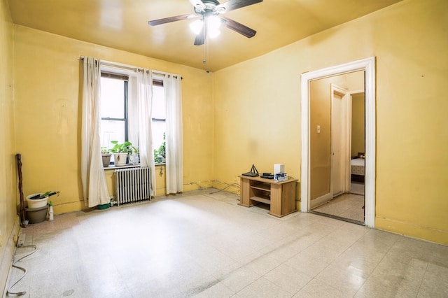 spare room featuring ceiling fan and radiator heating unit