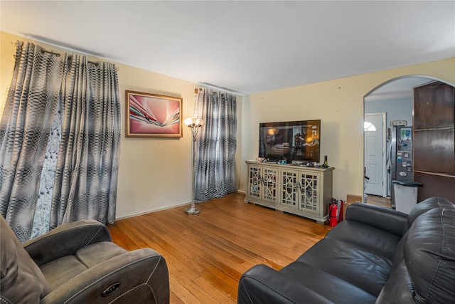 17718 Sayres Ave, Jamaica, NY 11433 - living room with arched walkways and hardwood / wood-style floors