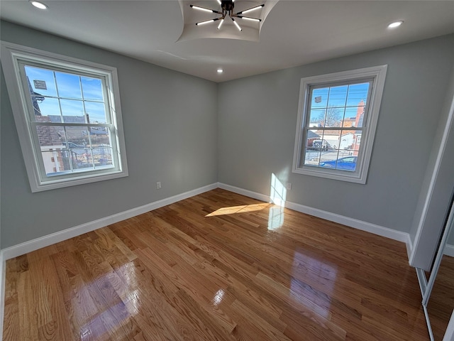 empty room with hardwood / wood-style floors