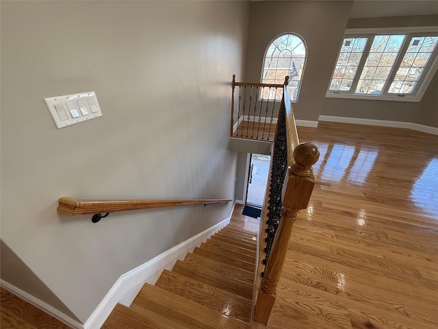 stairs with wood-type flooring