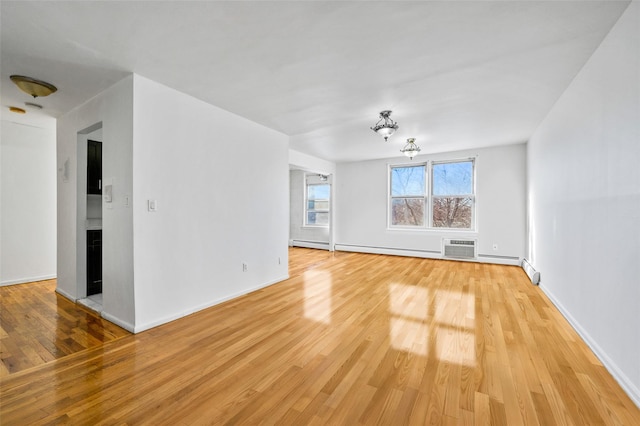 unfurnished living room with wood-type flooring and an AC wall unit