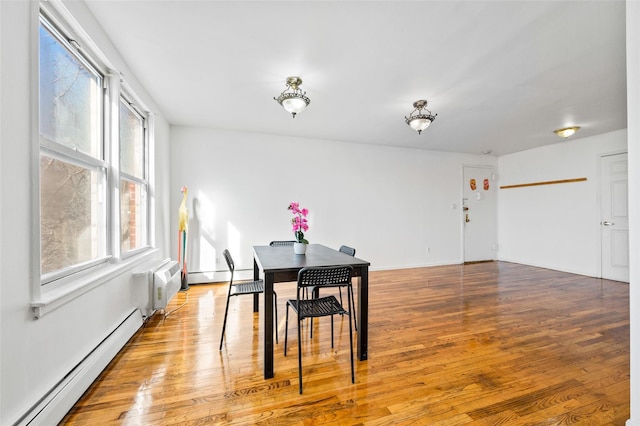 dining room with hardwood / wood-style floors, a baseboard radiator, and radiator