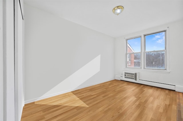 empty room with light hardwood / wood-style floors and a wall mounted AC