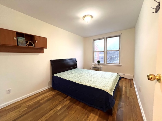 bedroom with dark wood-type flooring