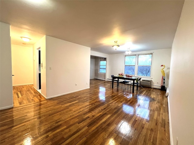 interior space featuring baseboard heating and dark hardwood / wood-style floors