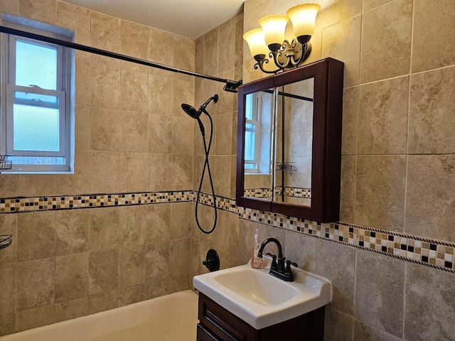 bathroom with backsplash, plenty of natural light, vanity, and tiled shower / bath combo