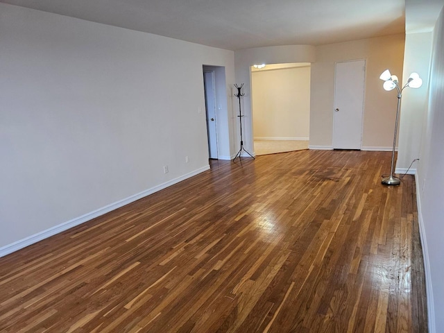 unfurnished room with dark hardwood / wood-style floors