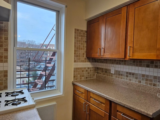 kitchen featuring backsplash and a healthy amount of sunlight