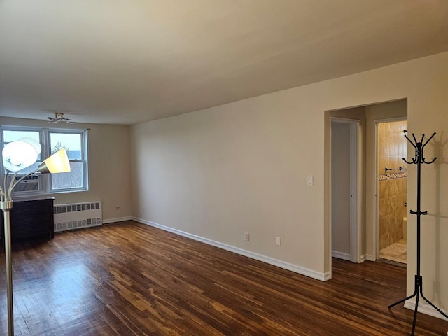 unfurnished living room featuring radiator, ceiling fan, and dark hardwood / wood-style flooring