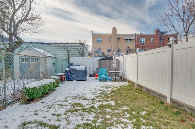 view of yard layered in snow